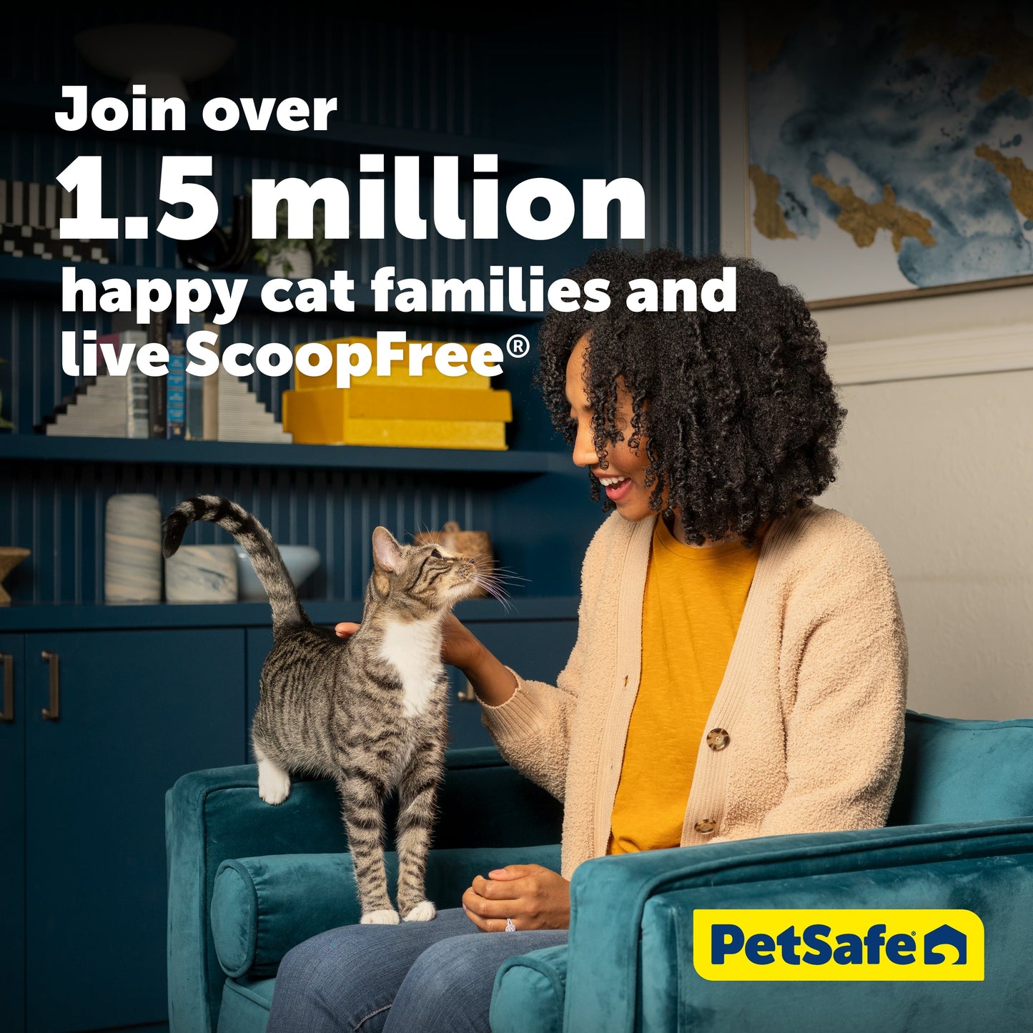 Woman sitting on a couch with a cat, promoting Petsafe's ScoopFree product.