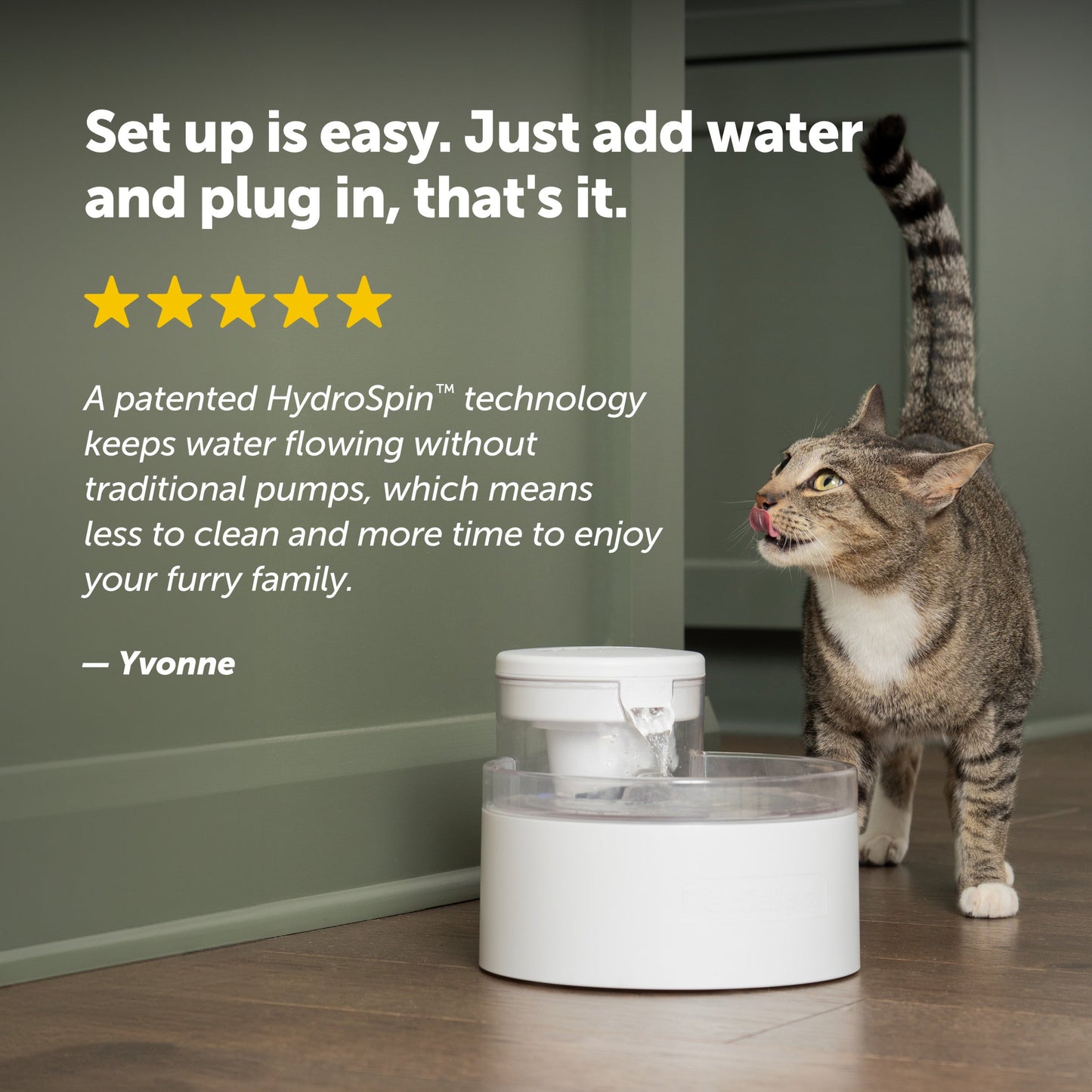 Cat drinking from a white pet fountain with text about HydroSpin technology.