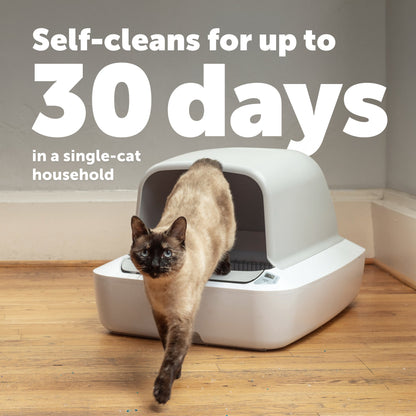 Cat using a self-cleaning litter box with text indicating it self-cleans for up to 30 days.