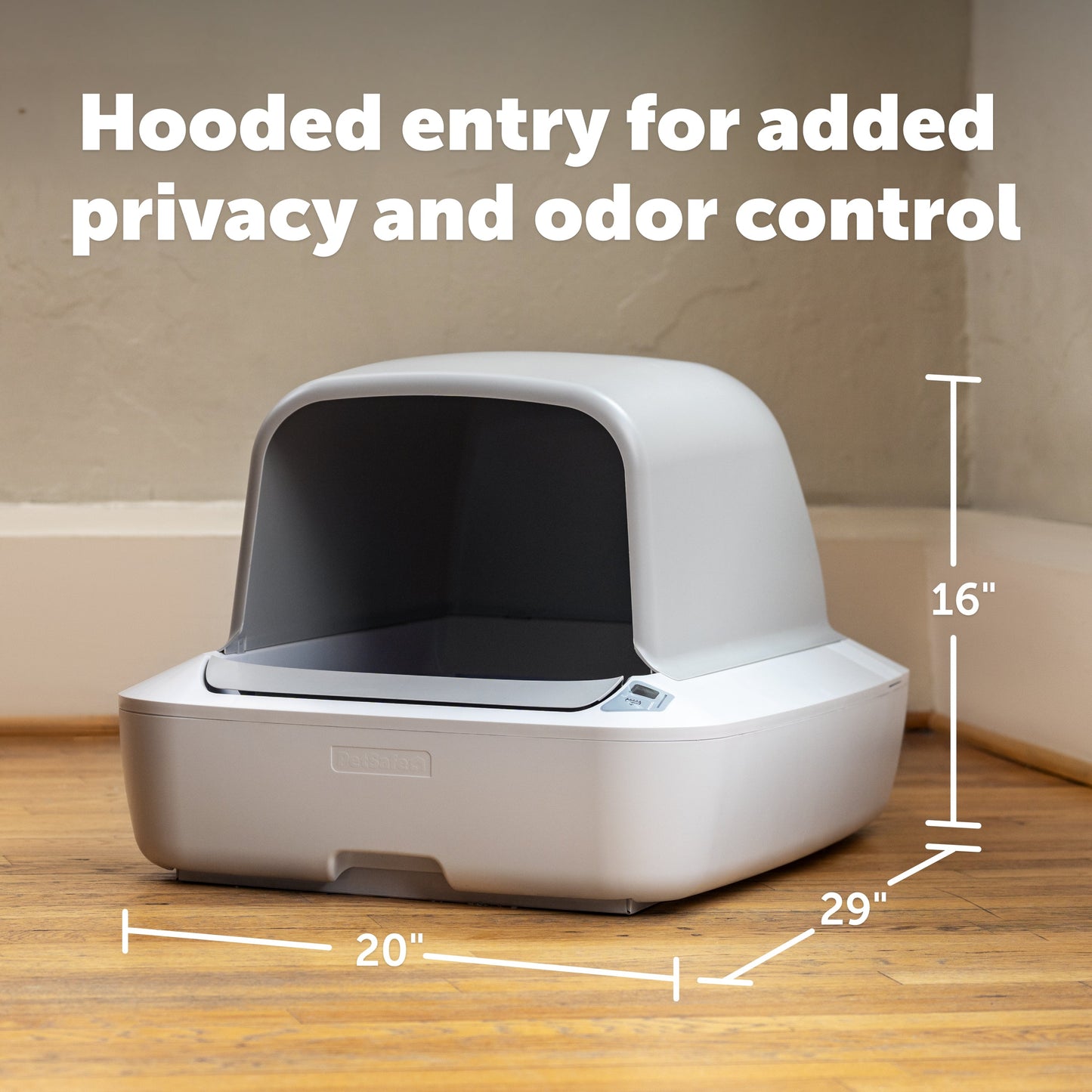 Pet litter box with hooded entry on a wooden floor, labeled for privacy and odor control.