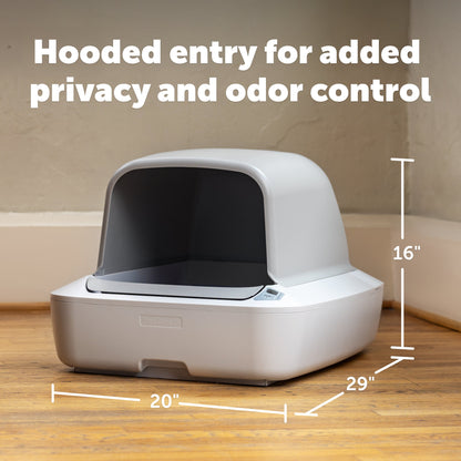 Pet litter box with hooded entry on a wooden floor, labeled for privacy and odor control.
